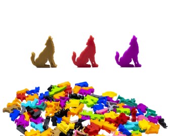 May include: A pile of colorful plastic animal figurines, including wolves, in various colors, such as red, purple, and brown. The figurines are arranged in a random pattern.