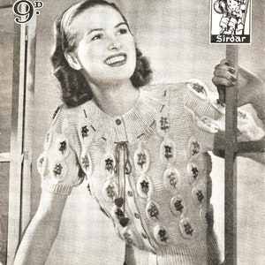 May include: A black and white vintage knitting pattern booklet with a woman wearing a white knitted sweater with a floral design. The cover of the booklet says "Bestway Tyrolean Knitting Designs No. 105" and "Inside Four Charming Models".
