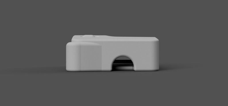 May include: A white plastic camera with a black lens. The camera has a small button on the top.