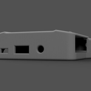 May include: A gray plastic case with a rectangular shape and rounded edges. It has three ports on the side, including a headphone jack, a USB port, and an ethernet port.