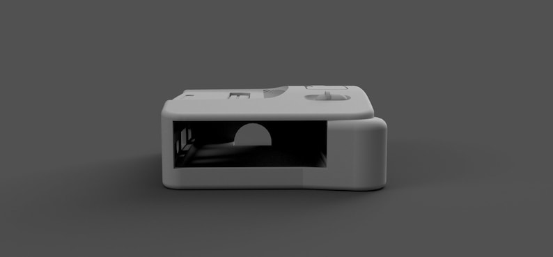 May include: A white plastic case with a rectangular opening and a small, round opening on the top. The case is designed to hold a small electronic device.
