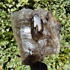 This stone is from Brazil and is a Skeletal Quartz crystal, Skeletal Window Smoky Quartz on large host of Smokey quartz crystal. 2.1 pounds