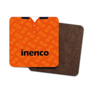 May include: Square coaster featuring an orange geometric pattern resembling a jersey, with a white collar and the word "inenco" in black. The second coaster is a dark brown cork.