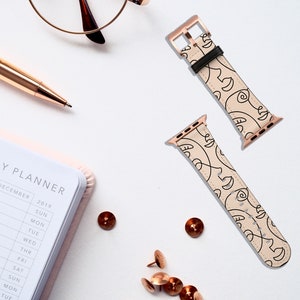May include: Two rose gold Apple Watch bands with a cream-colored leather strap and a black and white abstract face design.