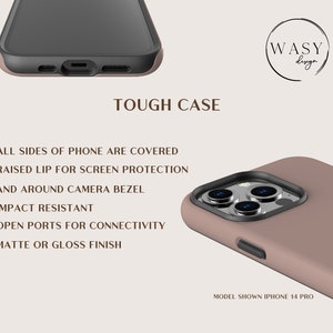 May include: A close-up of a phone case in a neutral color, with a black camera bezel and a black border. The text on the image reads "TOUGH CASE" and lists features like impact resistance and screen protection. The model shown is an iPhone 14 Pro.