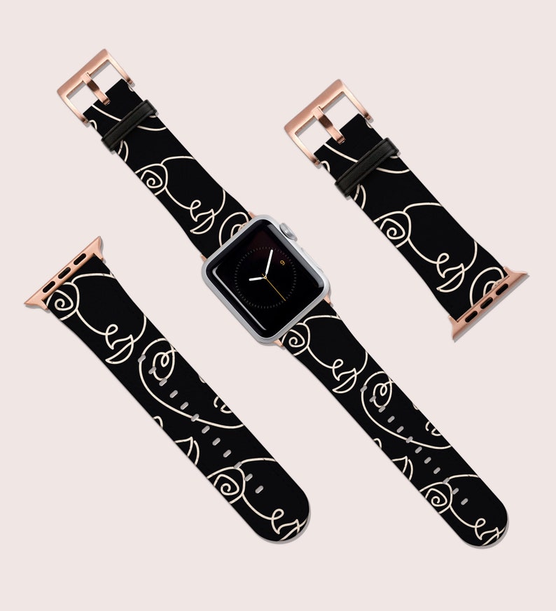 May include: A black Apple Watch band with a white abstract design. The band has a rose gold buckle.