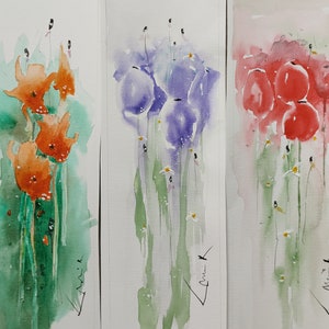 May include: Watercolor painting triptych featuring stylized flowers in orange, purple, and red. The artwork has a soft, blurred style with green stems and white accents. Each panel has a signature in the lower right corner.