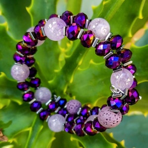 May include: A double-strand bracelet with purple iridescent beads and light pink and lavender stones.
