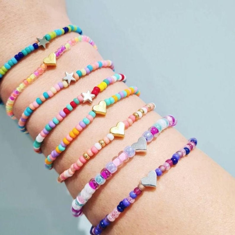 Photo showing different colours of bracelets available. From top to bottom: turquoise, neon, candyfloss, carnival, flower field, holiday pink, cupcake 4mm, happy purple.