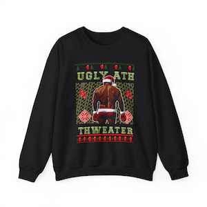 May include: Black crew neck sweatshirt with a Christmas-themed design. The design features a muscular figure in a Santa hat and boxing gloves, with the words "UGLY ATH THWEATER" in green and red.