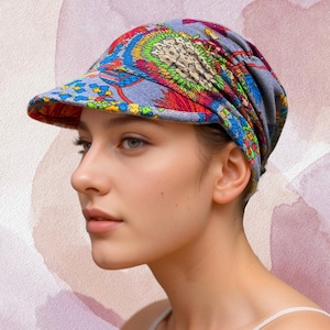 May include: A colorful, patterned cap with a short brim. The cap features a mix of blue, red, yellow, and green hues in an intricate design. The fabric appears soft and flexible, suitable for various head sizes. The cap is a stylish accessory.
