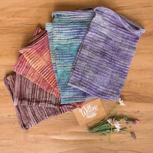 Peut inclure: Un ensemble de cinq échantillons de tissu tricoté rectangulaires aux coloris variés, notamment violet, bleu sarcelle, orange, rouge et marron. Chaque pièce présente une texture finement côtelée. Une petite carte beige avec le texte Willow est incluse.