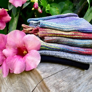 May include: A stack of six colorful striped knit socks. The socks are made of a soft, comfortable material and are perfect for everyday wear.