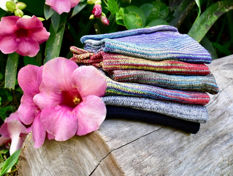 May include: A stack of six colorful striped knit socks. The socks are made of a soft, comfortable material and are perfect for everyday wear.