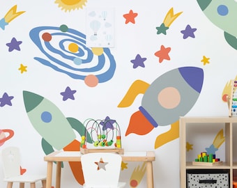 May include: A white play table with two white chairs and a wooden toy. The wall behind the table has a space-themed mural with rockets, stars, planets, and comets.