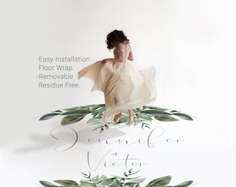 May include: A white oval floor sticker with a green leafy border and the text "Jennifer + Victor" in brown script. The sticker is designed for easy installation and removal, leaving no residue.