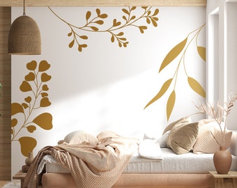 May include: A bedroom with a bed with a white duvet and a brown blanket. The wall behind the bed has a gold leaf design.