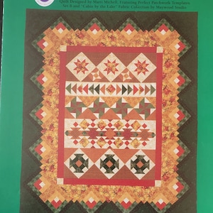 May include: Month 1 of the Cabin by the Lake quilt pattern, featuring a patchwork design with red, green, and yellow fabrics. The quilt is 86 inches by 103 inches. This is a not-so-block of the month quilt.