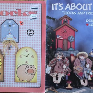 May include: Two books with clock-themed designs. The left book, "Easy Clocks," features clock designs with a sunflower, pig, and other shapes. The right book, "It's About Time," showcases clock designs with dolls and a schoolhouse clock.