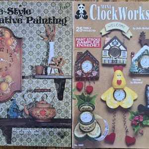 May include: Two vintage craft books. The left book is titled "Tole-Style Decorative Painting" with a clock illustration. The right book is "Mini ClockWorks" with various clock designs, including a house, heart, and cat.