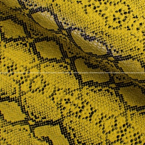 May include: Yellow faux snakeskin fabric with a black and white pattern. The fabric has a textured surface.