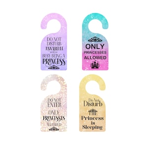 May include: Four princess-themed door hangers in various colors. Each hanger has a unique design and text, including "Do Not Disturb," "Only Princesses Allowed," and "Do Not Enter." The hangers are designed with a princess theme.