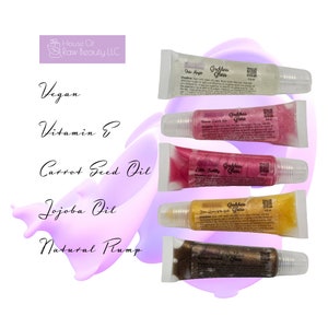 May include: Five tubes of lip gloss in different colors and flavors. The flavors are: Doe Magic, Dream Land Vibe, Little Fatty, Glam Queen of the Gods, and Lemonade. Each tube has a label that says "Goddess Glass" and includes a list of ingredients. The ingredients include: Vegan, Vitamin E, Carrot Seed Oil, Jojoba Oil, and Natural Plump.