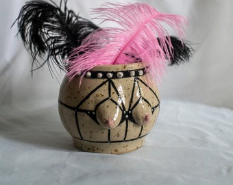 Stoneware ceramic boob vase with strappy harness lingerie in black on spotted clay with studded choker. Body tit/breast decorative vase