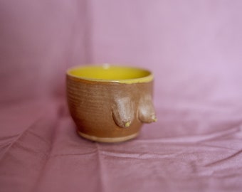 Ceramic stoneware small espresso coffee or tea cup in body form shape. Boob/breast/tit ceramic glazed with nude beige and yellow