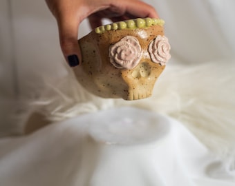 Skull and flower eyes stoneware witchy ceramic cup/bowl with blue interior and pink flowers. Decorative handbuilt handmade ceramics.