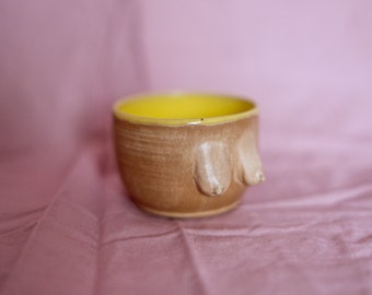 Ceramic stoneware small espresso coffee or tea cup in body form shape. Boob/breast/tit ceramic glazed with nude beige and yellow
