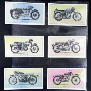 Puede incluir: Colecci&oacute;n de cromos de motocicletas antiguas. Cada cromo presenta una ilustraci&oacute;n detallada en acuarela de una motocicleta cl&aacute;sica, incluyendo modelos como Matchless G9, Velocette Thruxton y BSA Gold Star. Los cromos est&aacute;n en un archivador negro.