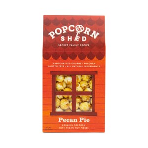 May include: A red and orange box with a window showing caramel popcorn with pecan pieces. The box says "Popcorn Shed" and "Pecan Pie Caramel Popcorn with Pecan Nut Pieces".
