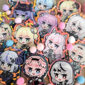 May include: A collection of colorful anime character keychains with holographic accents. The keychains feature various characters with different hairstyles, outfits, and expressions.