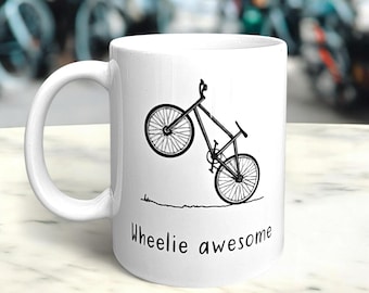 Taza "Caballito Genial" - Con un impactante diseño en blanco y negro de una bicicleta haciendo un caballito con un divertido juego de palabras. Regalo para el Día del Padre. Para los amantes del ciclismo.