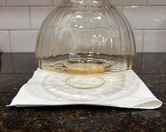 A stunning swirl vintage mushroom hurricane globe. It has a light amber tint. Perfect. No chips cracks crazing scratches etc. lovely.