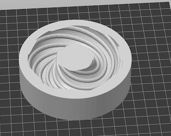 May include: A white ceramic mold with a spiral design. The mold is circular and has a hole in the center.