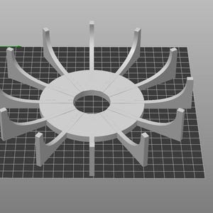 May include: A light gray, circular object with a central hole and radial supports. The object is designed with a series of curved arms extending outwards from the center, creating a symmetrical, fan-like appearance. The object is on a black and gray grid.