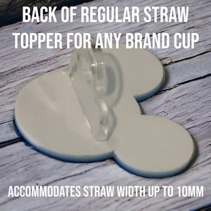 K&ouml;nnte beinhalten: Ein wei&szlig;er Plastik-Becher-Topper in Form eines Mickey-Mouse-Kopfes mit einem durchsichtigen Plastik-Strohhaltern an der R&uuml;ckseite. Der Text "BACK OF REGULAR STRAW TOPPER FOR ANY BRAND CUP" befindet sich oben im Bild. Der Text "ACCOMMODATES STRAW WIDTH UP TO 10MM" befindet sich unten im Bild.