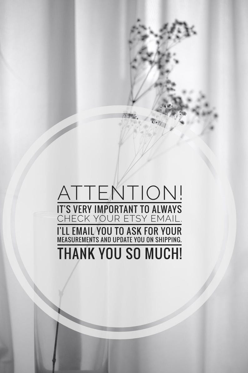 May include: Black and white image with text that reads "ATTENTION!" and other important information. A clear glass vase holds delicate, dried flowers. The background is a soft, blurred curtain.