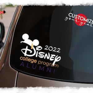 May include: A white decal on a car window features the Disney logo with "2022" and "college program ALUMNI" in orange and purple. The text "CUSTOMIZE your year!" is above the logo, with a red circle.
