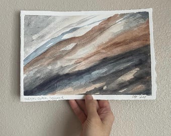 May include: Abstract watercolor painting on paper with shades of blue, brown, and gray. The painting is signed "Indigo, Cutch, Logwood" and dated "04 '24".