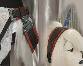May include: A black and red headband with a blue horn attached. The headband is made of faux leather and has a braided design. The horn is made of plastic and has a blue and white paint job.