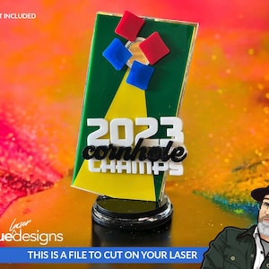 May include: A green and yellow cornhole trophy with the text "2023 cornhole CHAMPS" in white letters. The trophy has a red, blue, and white design on the top.