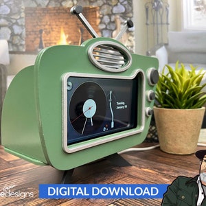 May include: A green retro-style TV stand with a phone screen inside. The stand has a silver trim and a wooden base. The phone screen shows a clock and the date "Tuesday, January 10".
