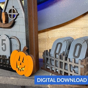 May include: A wooden Halloween countdown calendar with a haunted house, a pumpkin, and a fence. The calendar has a digital display that shows the number of days until Halloween. The display shows "45" days until Halloween. The calendar also includes a set of numbers that can be used to change the display. The numbers are in a fence-like holder. The numbers are "00".