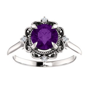May include: A silver ring featuring a large, round, purple amethyst gemstone set within a delicate, ornate filigree design and smaller diamonds.