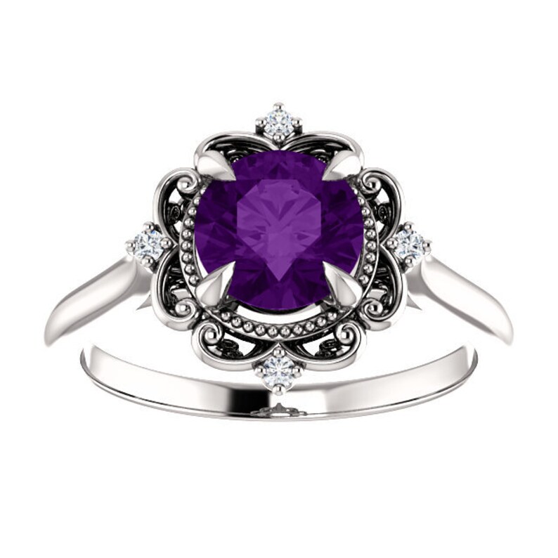 May include: A silver ring featuring a large, round, purple amethyst gemstone set within a delicate, ornate filigree design and smaller diamonds.
