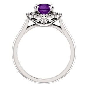 May include: A silver ring featuring a large, purple amethyst gemstone encircled by a halo of smaller diamonds. The ring has a delicate, ornate design.