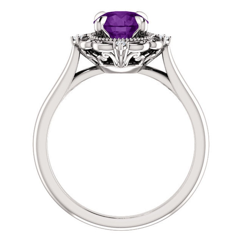May include: A silver ring featuring a large, purple amethyst gemstone encircled by a halo of smaller diamonds. The ring has a delicate, ornate design.